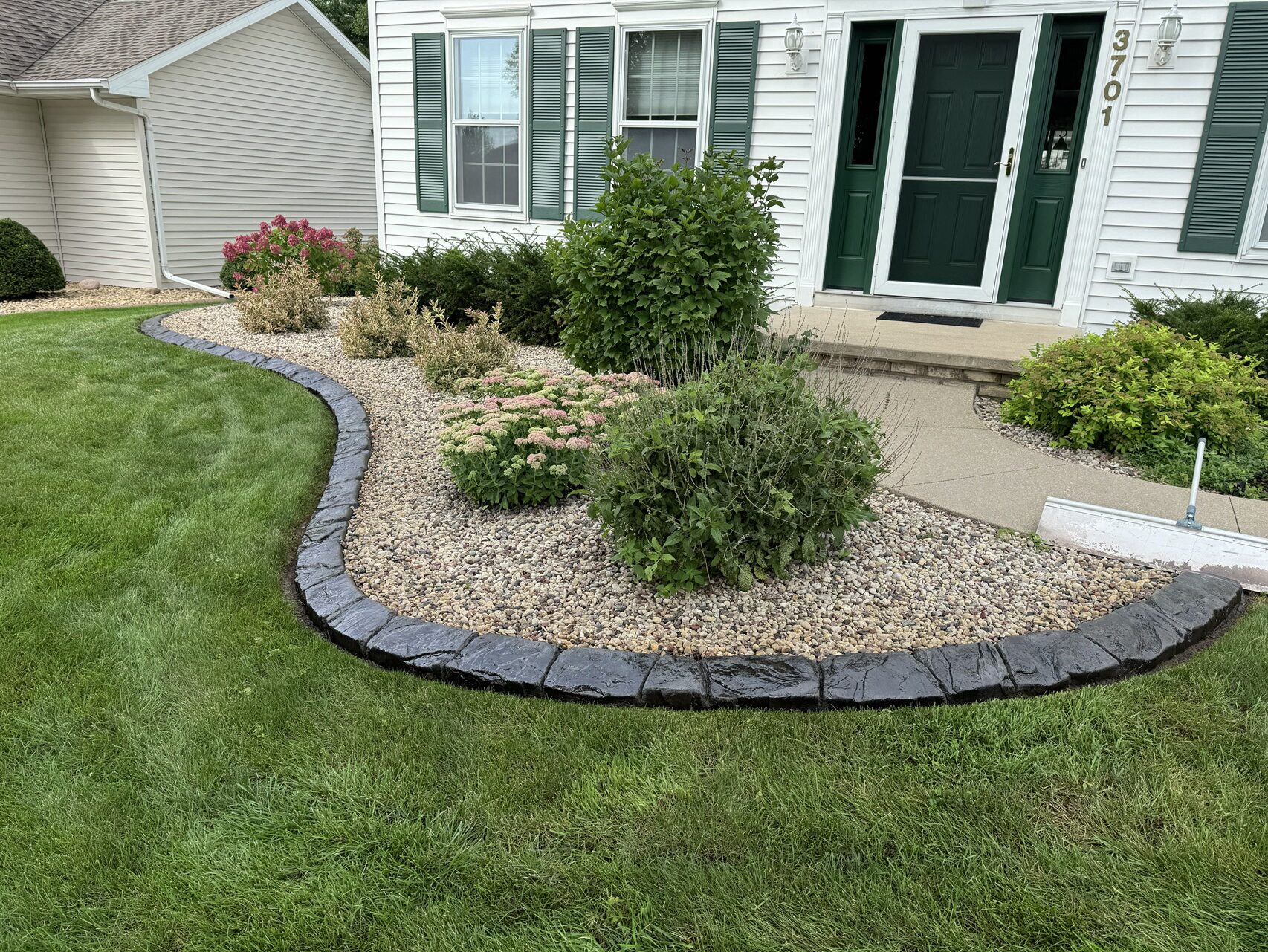 Landscape professionals installing a designed outdoor space